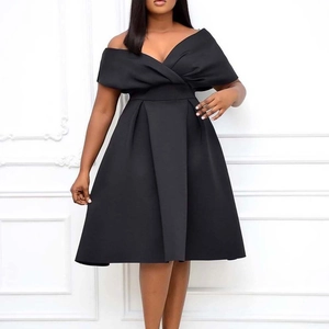 Detail of elegant black off-the-shoulder pleated dress with crossed neckline and A-line waist