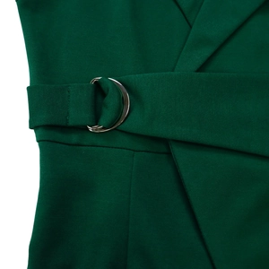 Detail view of dark green jumpsuit featuring adjustable waist belt with silver D-rings