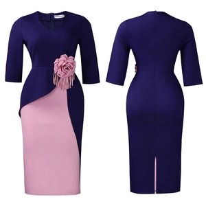 Detail of purple dress featuring pink 3D flower decoration and ruffled half sleeves
