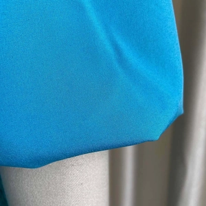 Macro shot of azure blue high-density woven fabric texture on summer two-piece set