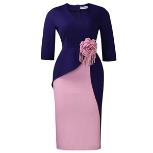Detail of V-neck navy and pink dress with fabric flower and tassel on waist