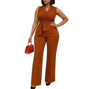 Detail of caramel sleeveless suit set with cross waist tie and wide leg trousers