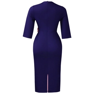 Detail of dark blue bodycon midi dress featuring back slit and pink lining detail