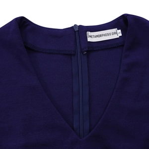 Detailed view of the V-neckline and invisible zipper on this dark blue pleated dress