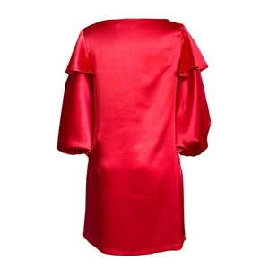 Détail du tissu en satin rouge brillant et de la texture élégante des manches bouffantes