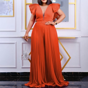 Orange pleated wide leg jumpsuit with deep V-neck and ruffled shoulders for party wear