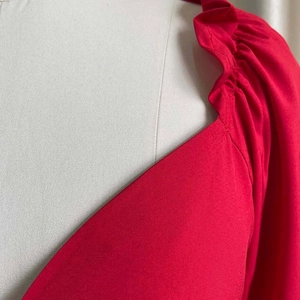 Close-up detail of the ruffled square neckline on a red stylish two-piece summer set