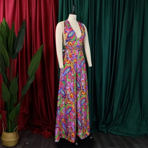 Detail of vibrant paisley print on bohemian halter neck wide-leg jumpsuit with V-neck