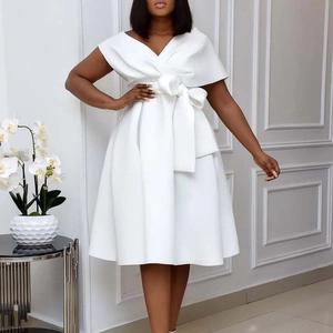 Elegant white V-neck mini dress with waist bow and cape sleeves on model