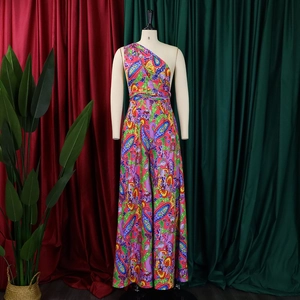 Detail of colorful paisley print on one-shoulder wide-leg jumpsuit with bohemian style