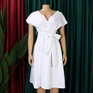 Detail of white V-neck short sleeve dress with adjustable waist bow and A-line skirt