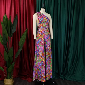 Detail of vibrant paisley print one-shoulder wide-leg jumpsuit on a display mannequin