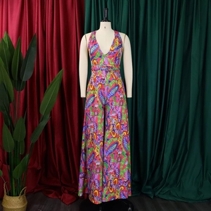 Detail of vibrant paisley print on bohemian halter neck wide-leg jumpsuit fabric