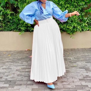 Elegant light blue puff sleeve shirt paired with a white pleated maxi skirt and belt