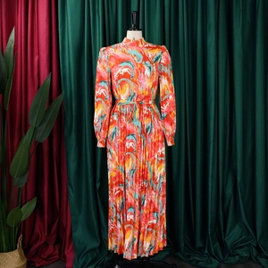 Detail of high neck pleated dress with abstract print and drawstring waist ties