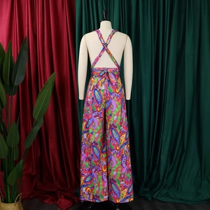 Detail view of the criss-cross back straps and paisley print on the wide-leg jumpsuit