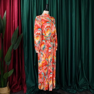 Detail of high neck pleated maxi dress with abstract print and waist tie belt