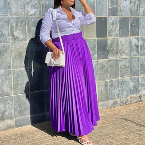 Detail of high-waist purple pleated maxi skirt with matching belt and elegant drape
