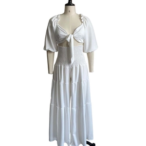 Detail of white two-piece set with V-neck tie-front top and high waist wide leg pants