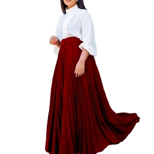 Detail of elegant pleated red maxi skirt with waist belt and white chiffon blouse