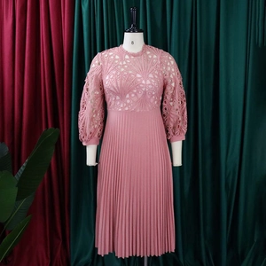 Detailed lace crochet pattern on the upper bodice and sleeves of a pink pleated midi dress