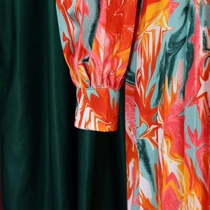 Detail of multi-color marble print dress featuring fine pleats and elastic cuffs