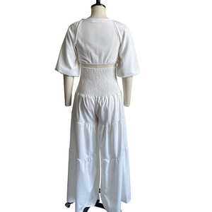 Detail view of white smocked waist crop top and wide leg pants set on a mannequin