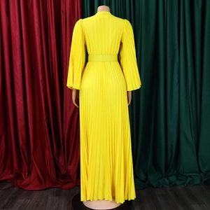 Vue détaillée d'une robe longue plissée jaune avec ceinture assortie et plis verticaux