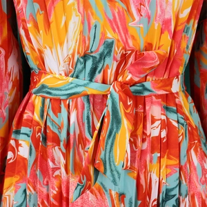 Detail of colorful marble print dress with pleated texture and matching waist tie
