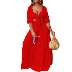 Detail of red vacation two-piece set featuring a deep V-neck tie-front top and tiered pants