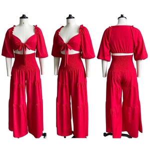 Detailed views of red two-piece set featuring lace-up crop top and layered wide-leg pants