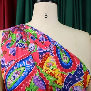 Detailed close-up of colorful paisley print fabric on a bohemian jumpsuit for women