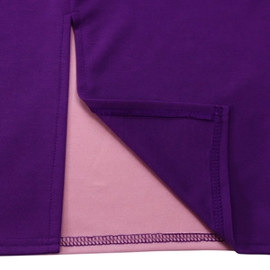 Detailed close-up of dark purple knit fabric slit with smooth pink lining and stitching