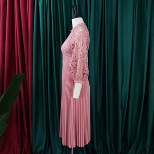 Close-up of pink lace hollow-out bodice and fine pleated chiffon dress texture