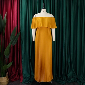 Detail of mustard yellow off-shoulder pleated maxi dress with ruffled layered neckline