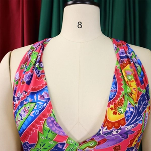 Detail of multi-way halter jumpsuit with vibrant ethnic paisley print on silk-like fabric