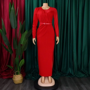 Detail of red long sleeve dress with mesh splicing, pleats, and side slit on mannequin