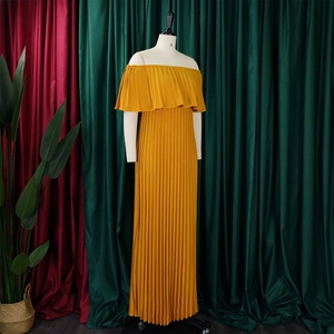 Detail of off-shoulder mustard yellow pleated maxi dress with elegant ruffles on mannequin
