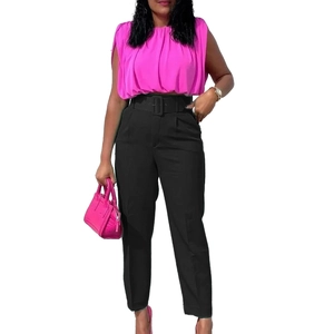 Detail of high waisted black trousers with belt paired with a rose pink sleeveless blouse