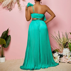 Women's emerald green one-shoulder crop top and high-waisted pleated maxi skirt set