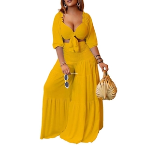 Detailed view of the yellow tie-front crop top with puffy sleeves and wide-leg tiered pants
