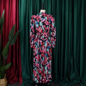 Detailed view of long-sleeved floral dress with pleated hem and drawstring waist
