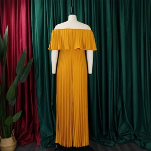 Detail of ginger yellow off-shoulder pleated maxi dress with elegant ruffle neckline