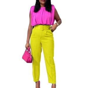 Detail of high-waist straight pants with matching square buckle belt and sleeveless top