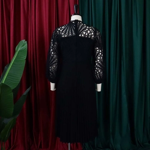 Detail of elegant black lace crochet and hollow-out embroidery on long-sleeve dress