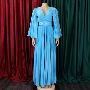 Détail d'une robe longue bleu ciel avec col en V, texture plissée et ceinture à boucle assortie