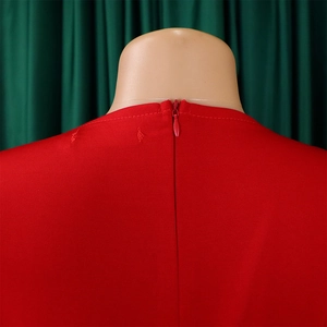 Detail view of the seamless back invisible zipper on a red crew neck mesh patchwork dress