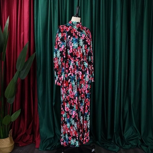 Detail of vintage long sleeve maxi dress featuring floral print and waist tie design