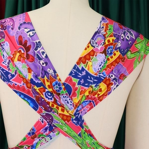 Detail of cross-back tie design on colorful floral printed jumpsuit for women