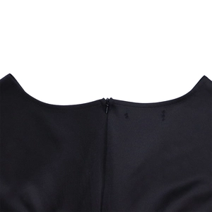Close-up of elegant black dress featuring back invisible zipper and neat stitching details